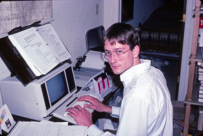 Chris Conley programming at a computer in 1985